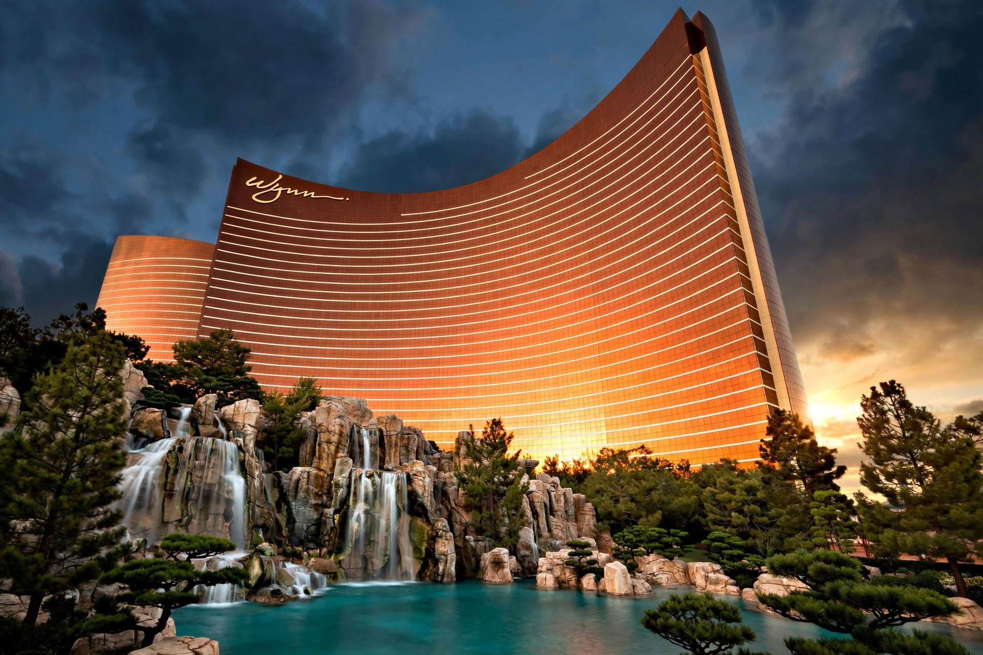 Wynn Las Vegas curved bronze tower reflected against azure waters